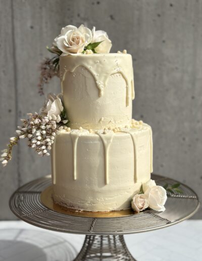 Three-tier white wedding cake with textured buttercream