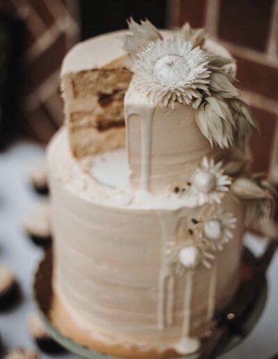 White wedding cake decorated with dried flowers