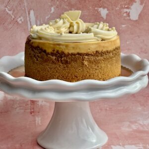 Classic baked cheesecake on a white cake stand