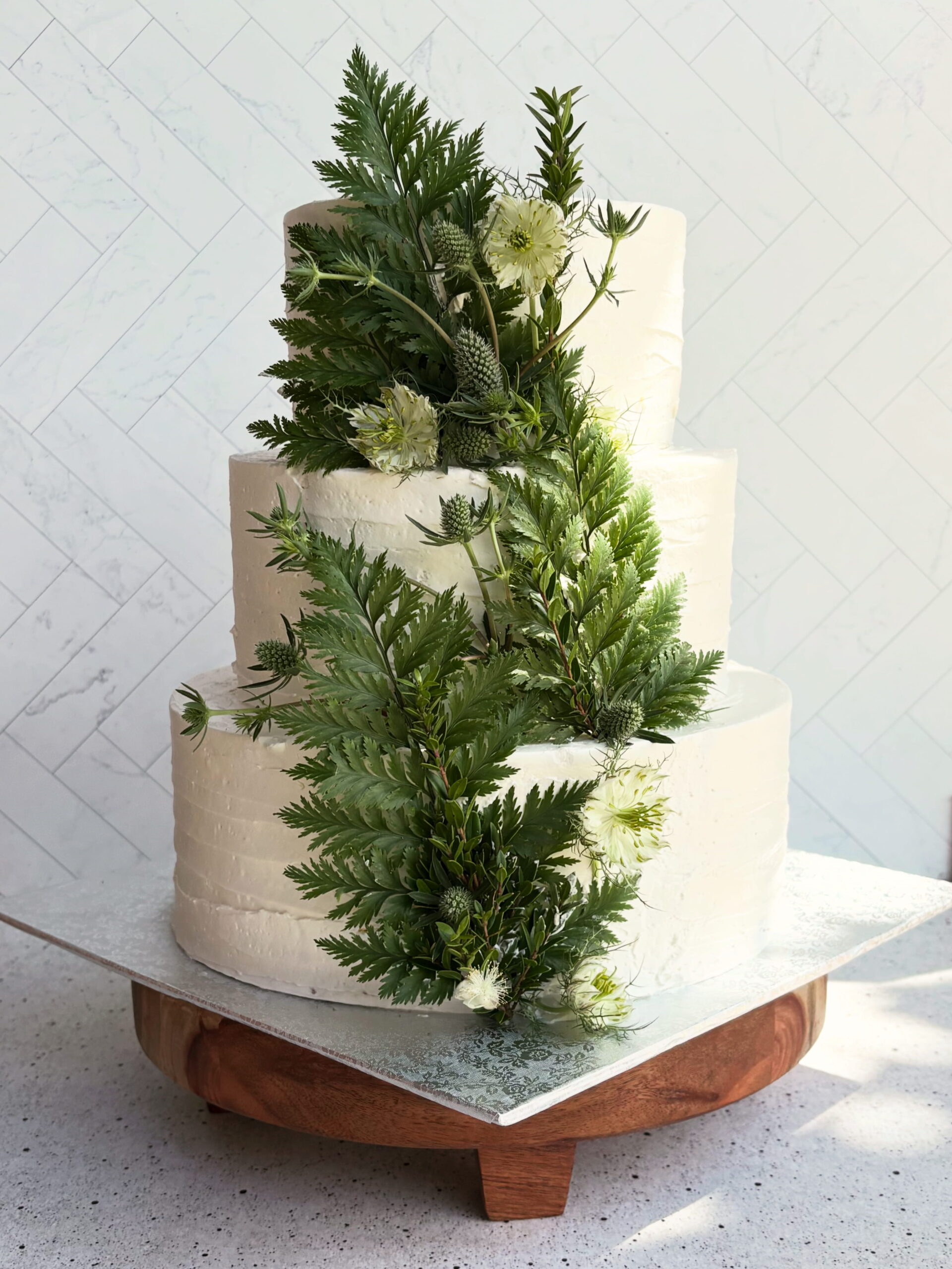 Jess-and-Moss-Wedding Two-tiered wedding cake with fruit layers inside
